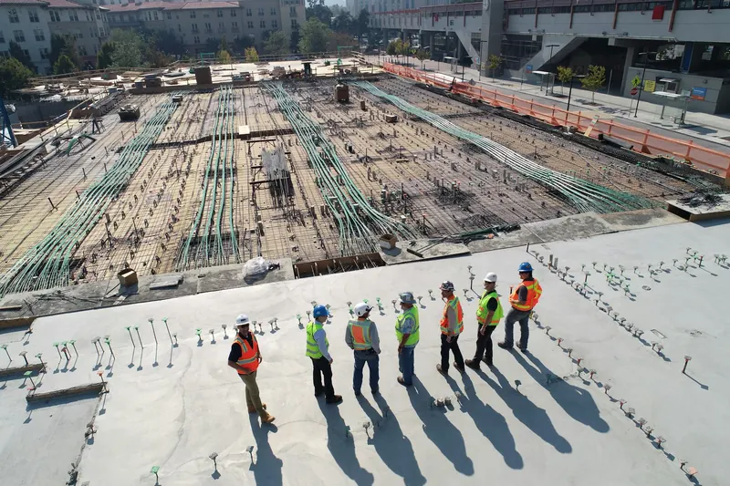 Site supervisor briefing a team of workers in high-visibility safety gear