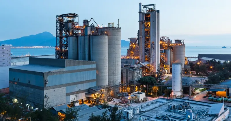 Industrial manufacturing plant with production silos at dusk